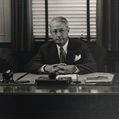 Warren C. Platt sitting at his desk